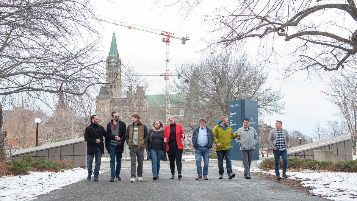 Caption: Team WithYouWithMe in front of the Parliament Hill, Downtown Ottawa.