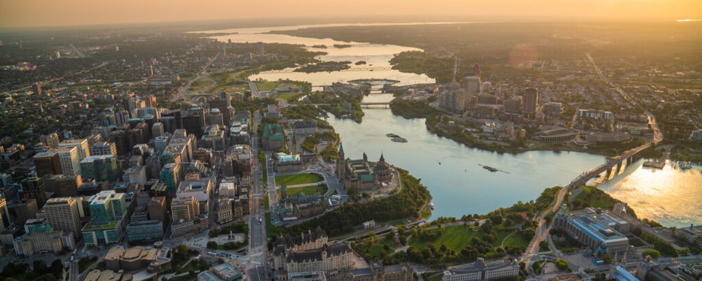 An aerial sunset view of the downtown Ottawa area, with the Ottawa river in view.