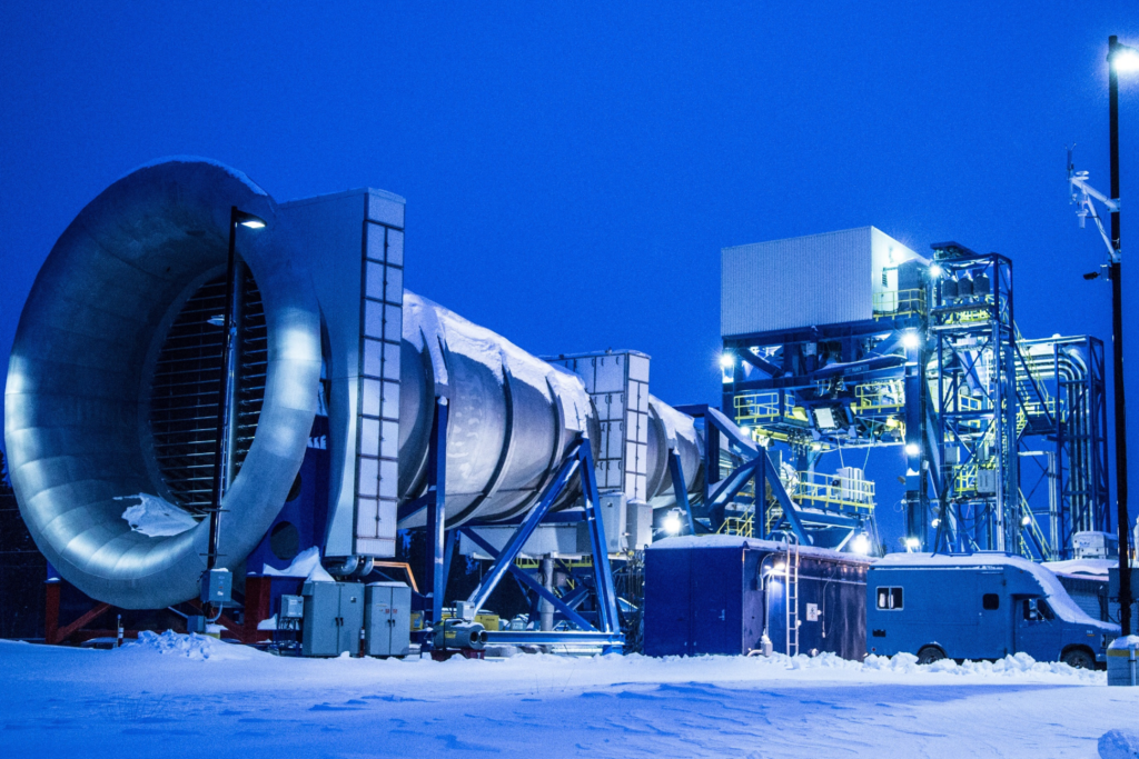 An image of an engine test facility in a wintry evening setting.