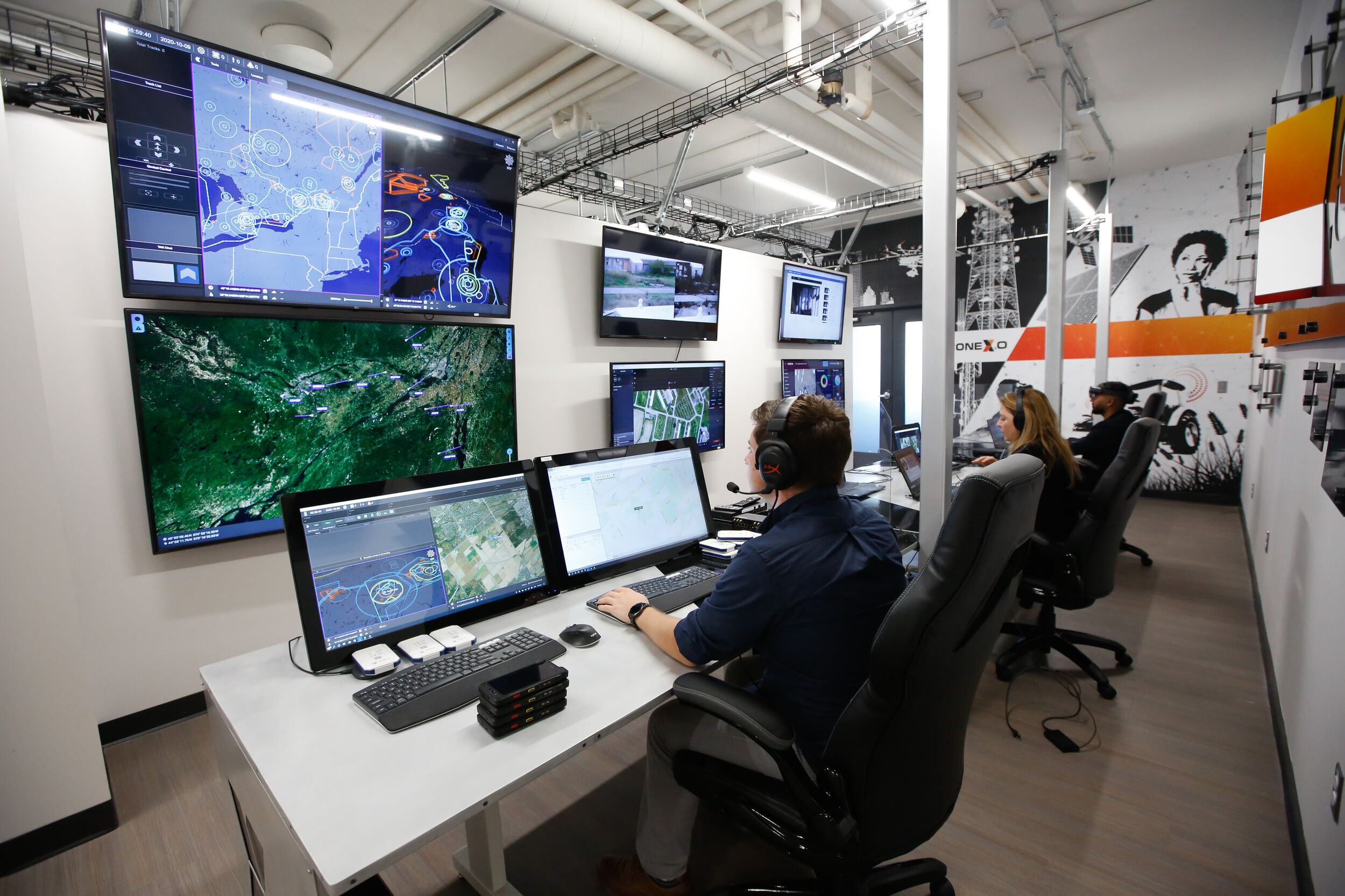 Professionals in a modern operations center monitor multiple screens displaying maps, data, and live feeds, highlighting Ottawa’s advanced technology and innovation ecosystem.