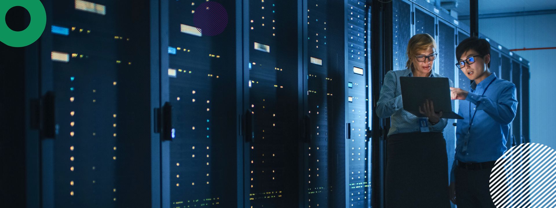 A featured image for a blog. The image shows two people standing and examining a laptop in a dark server room.