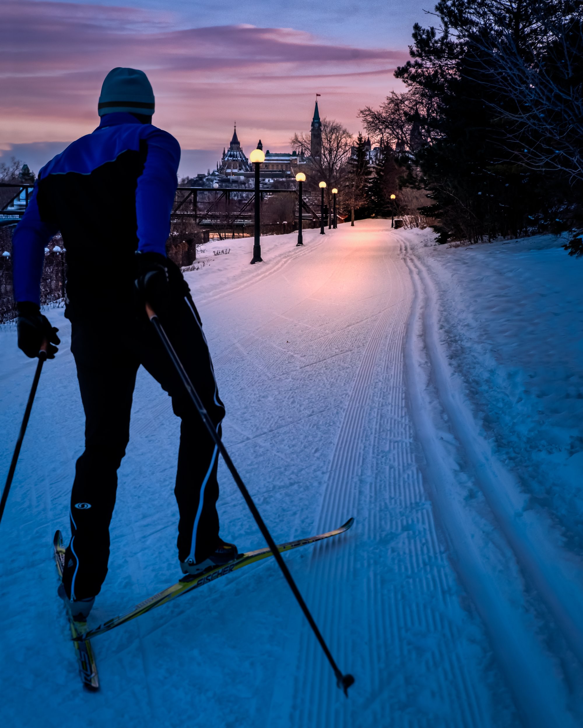Cross-country skiing along a lit winter trail near downtown Ottawa, highlighting active outdoor living in all seasons.