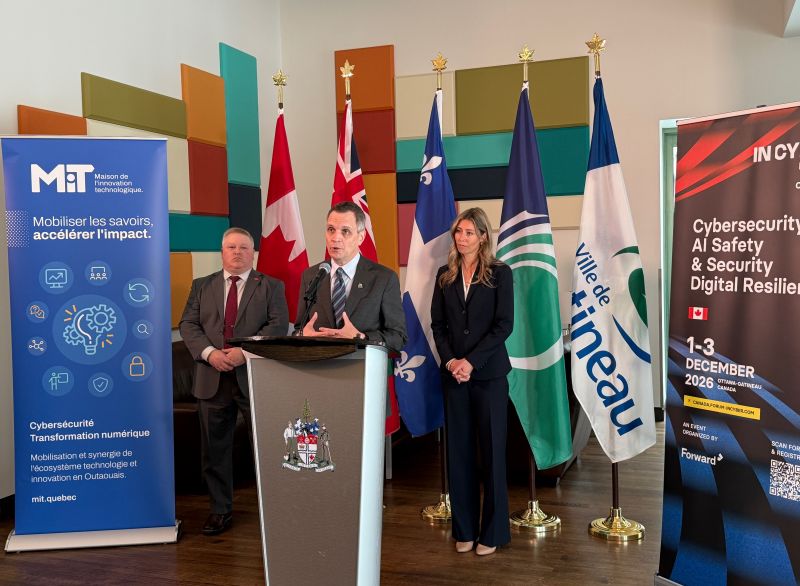 Government and industry leaders speaking at a cybersecurity event, highlighting collaboration in digital security and innovation.
