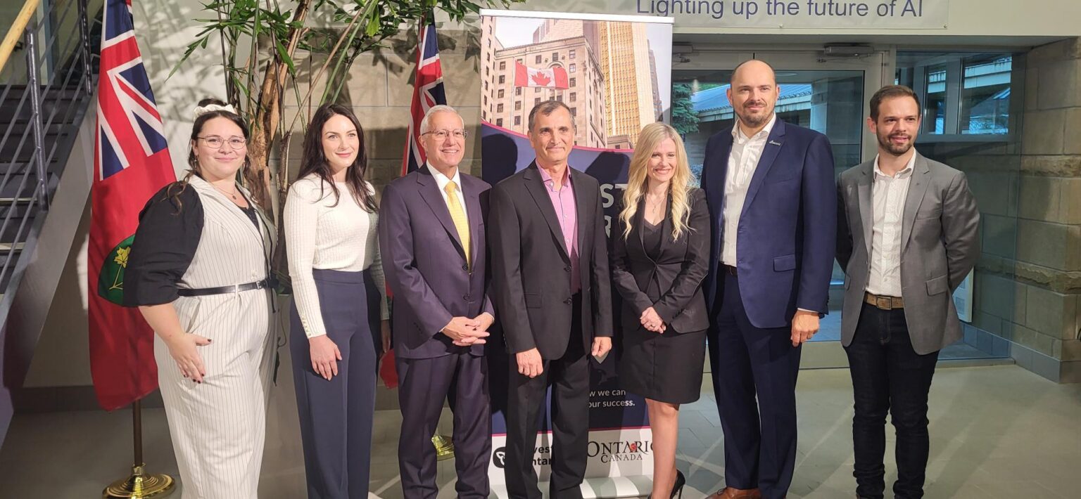 Group of business and government leaders at an event focused on AI and innovation, highlighting collaboration in Ottawa’s tech sector.