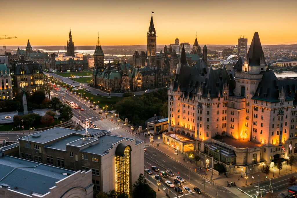 Aerial view of downtown Ottawa at sunset featuring Parliament Hill, representing proximity to government, business, and opportunity.