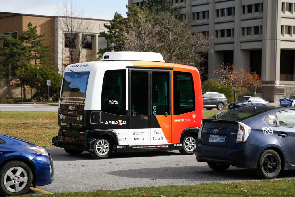Autonomous shuttle operating on city streets in Ottawa, demonstrating real-world testing of connected and self-driving mobility.